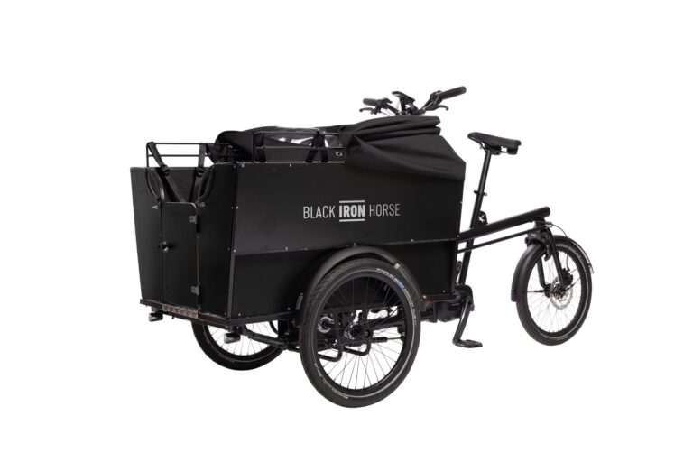 Front left view of the Black Iron Horse OX cargo bike with the rain cover down